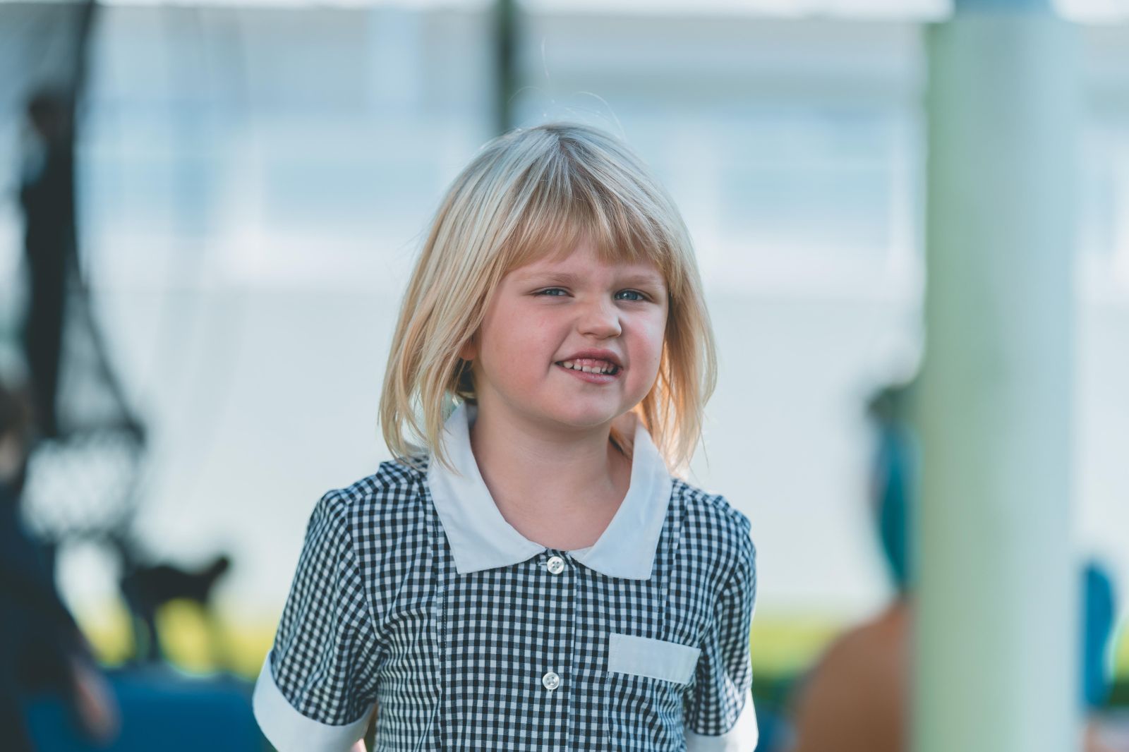 A student playing in the playground with a big smile